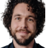 Portrait of Chris M., a brown-haired man in his mid-30s, smiling confidently