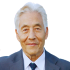 Portrait of Dan S., an older gray-haired Asian man, smiling with satisfaction.