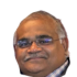 Portrait of Sunil W., older Indian man with a smile