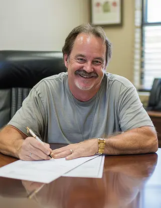 Portrait of Jim A., an older balding man, smiling with relief.