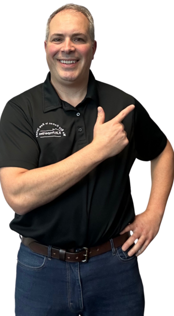 Justin from Webuyhomesinnewjersey.com smiling and pointing over his shoulder, ready to assist.